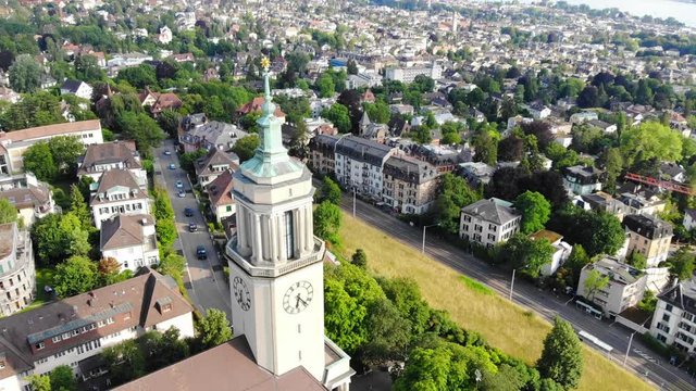 Beautiful drone aerial of Z&uuml;rich, the biggest city in Switzerland. Side view of a church. Shot is moving up.