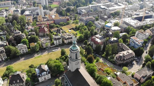 Beautiful drone aerial of Z&uuml;rich, the biggest city in Switzerland. Shot tilting down on church and street with moving cars on.