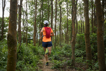 Ultramarathon runner running in tropical rainforest