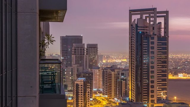 Tecom and Greens district aerial view from top night to day transition timelapse. Illuminated office and residential buildings from above near golf cource.