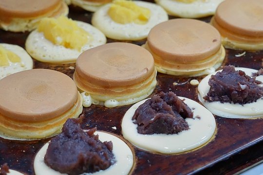 Obanyaki also known as Imagawayaki, Japanese dessert made from flour mixed with egg, cooked in pan stove and filled with custard cream, purple sweet potato and most popular is red bean.