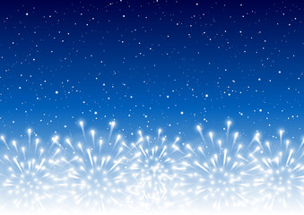 Shiny fireworks border on blue starry sky - horizontal background for Christmas and New Year holiday design
