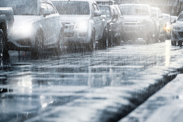 Hard rain fall in the city with blurry cars .Selective focus.