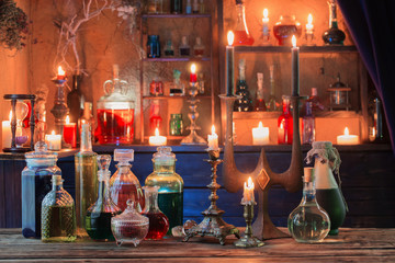 magic potions in bottles on wooden background