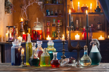 magic potions in bottles on wooden background