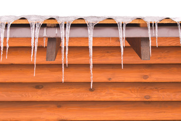 Icicles hanging from the roof. The concept of a cold winter.
