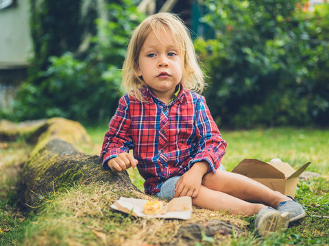 Little toddler enjoying a picnic in the park