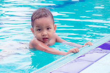  asian children having fun in a swimming pool at thailand