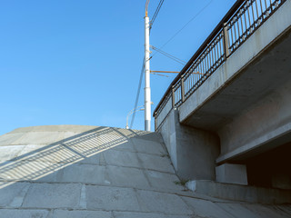 Road bridge over the river. Bottom view of concrete supports and metal structures.