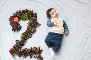 The concept of a two month old baby. Close up portrait of 2 months baby eye contact pink rose gold. figure 2