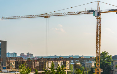 A fragment of the construction of a residential building with a construction crane in the center of Kiev, Ukraine.