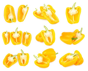Set of cut ripe yellow bell peppers on white background