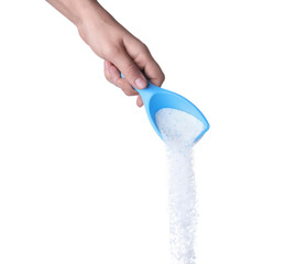 Woman pouring laundry detergent from measuring container against white background, closeup