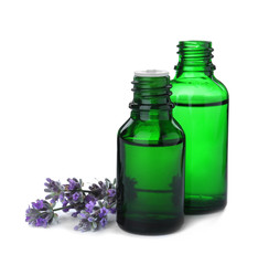 Bottles of essential oil and lavender flowers isolated on white