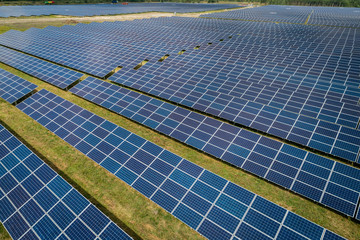 Aerial top view of a sun lit solar panels