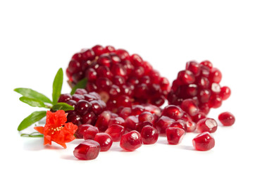 Parts of a pomegranate with pomegranate seeds and leaves, flowers isolated on white background