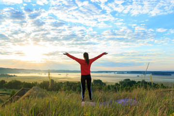 Girl in the nature doing yoga exercise for fitness.