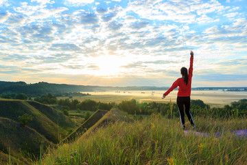 Girl in the nature doing yoga exercise for fitness.
