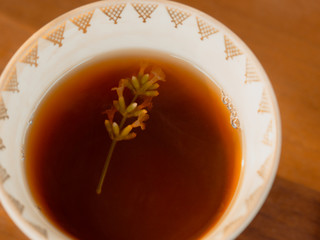blooming lavender sprig in black tea