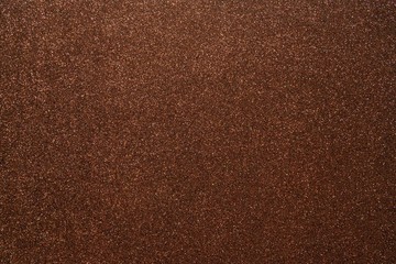 Brown glitter abstract shiny background. Design paper texture for decoration and design of Christmas, New Year or other holiday pictures. Beautiful packaging material.