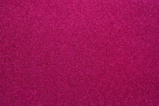 Magenta glitter. Abstract shiny background. Design paper texture for decoration and design of Christmas, New Year or other holiday pictures. Beautiful packaging material.
