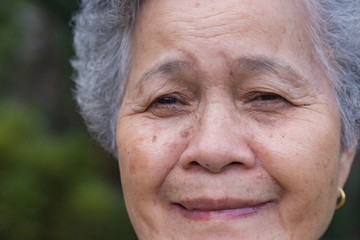 Close-up of face senior woman smiling happiness