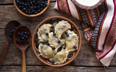 Preparing dumplings with blueberry. making pierogi or pyrohy, varenyky, vareniki. Traditional...