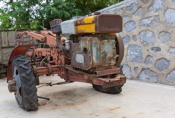 Outdoor scrapped rusty Chinese style walking tractor wreck