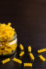 Delicious traditional pasta spiral fusilli macaroni in the glass jar