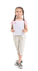 Happy girl with answer sheet for school test on white background