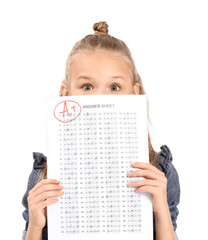 Girl with answer sheet for school test on white background