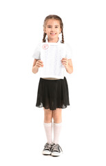Happy girl with answer sheet for school test on white background
