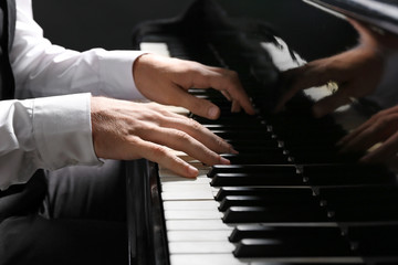 Fototapeta na wymiar Man playing grand piano at the concert, closeup