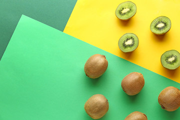 Many tasty ripe kiwi on color background