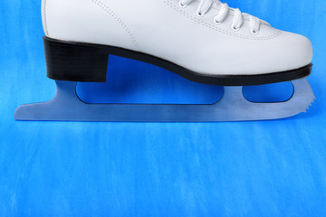 White figure skate against the blue background. Copy space