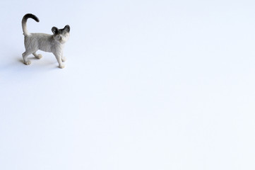 Figurine of a cat on white background