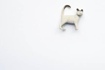 Figurine of a cat on white background