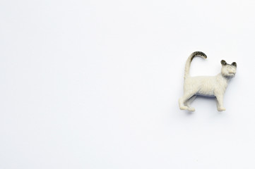 Figurine of a cat on white background