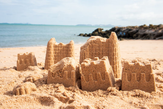 Sand Castle on the beach. Background the sea and the rock.
