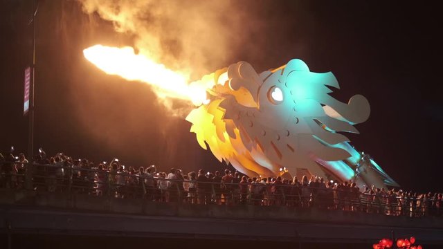 The Dragon Bridge is the icon of Da Nang city in Vietnam. It was designed and built in the shape of a dragon and to breathe fire. A big crowd experiences the Dragon's head breathing fire at night