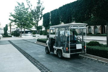 View of the street in Tivat in Montenegro. A tourist electric car is parked on the street.