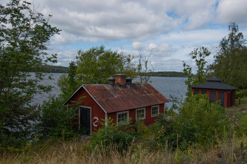 Old Swedish rural Falu red houses at the island Lovö in Stockholm a summer day