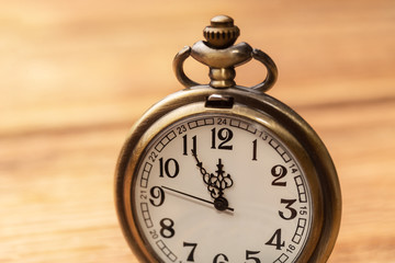 Old clock on a wooden background
