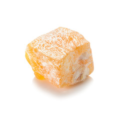 Turkish delight. Pistachio rahat locum with nuts, one piece of sweet oriental delights in powered sugar. Close-up view.