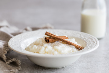 Rice pudding with cinnamon and a bottle of milk