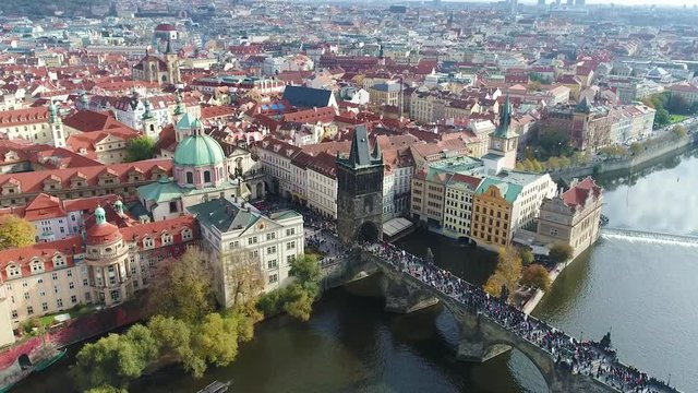 Tourists stroll along the Charles Bridge in Prague, Panoramic view from above, Vltava River, flight over the Charles Bridge, Prague, October 20, 2017