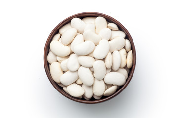 White kidney beans in a wooden bowl. Isolated on white background. Top view.