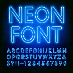 Neon alphabet font. Blue neon light bulb letters and numbers on brick wall background. Stock vector typeface for your typography design. © epifantsev