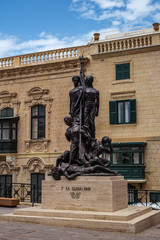street with traditional balconies and old buildings in historical city Valletta Malta