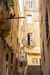 street with traditional balconies and old buildings in historical city Valletta Malta